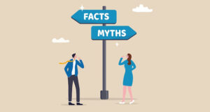 Two people looking up at signposts labelled facts and myths that are pointing in opposite directions