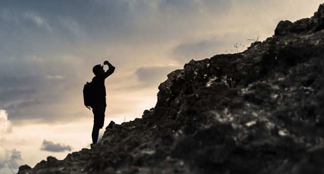 PXL_20230507_142535864 person in profile and silhouette looking up a rocky hill