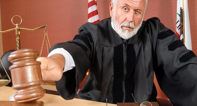 PXL_20230507_142535864 Judge in black robe pounds gavel
