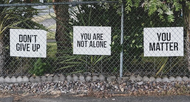 PXL_20230507_142535864 Series of rectangular signs attached to chain-link fence: Don't give up, You are not alone and You matter