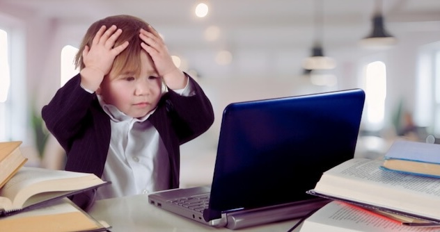 PXL_20230507_142535864 Worried toddler in office with laptop holds head in hands
