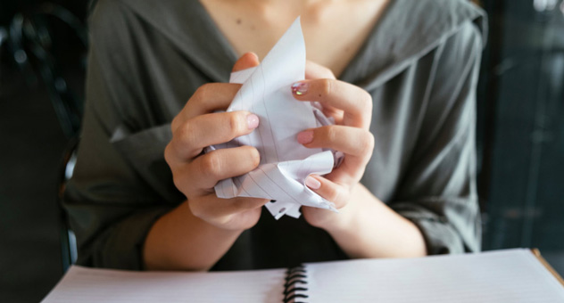 hands-crumpling-paper