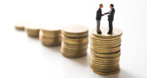 Shaking hands coin stacks