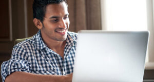 Smiling man at laptop