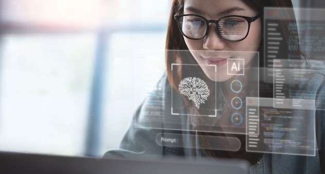 Person with long, dark hair and glasses smiles softly at laptop screen, with reflection of AI tool prompt window over their face